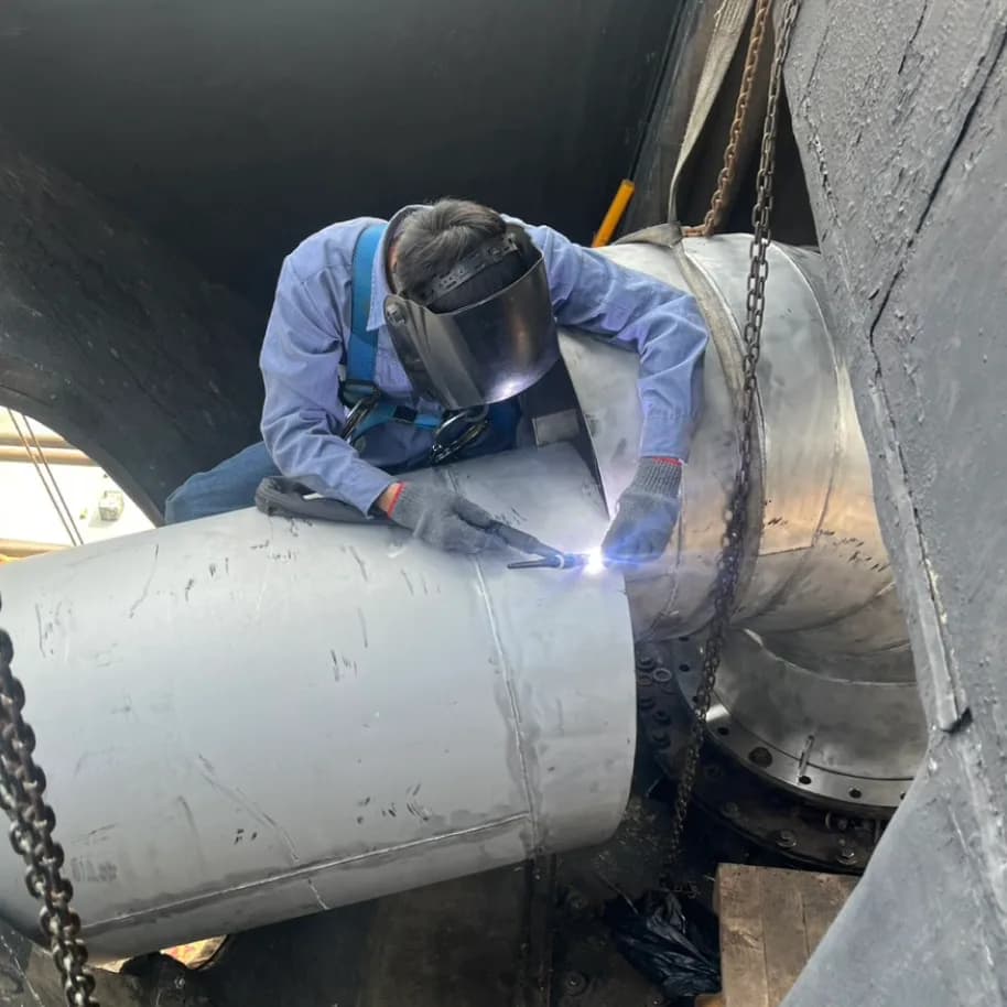Welding the joint between sections — the run has to go continuously right around.