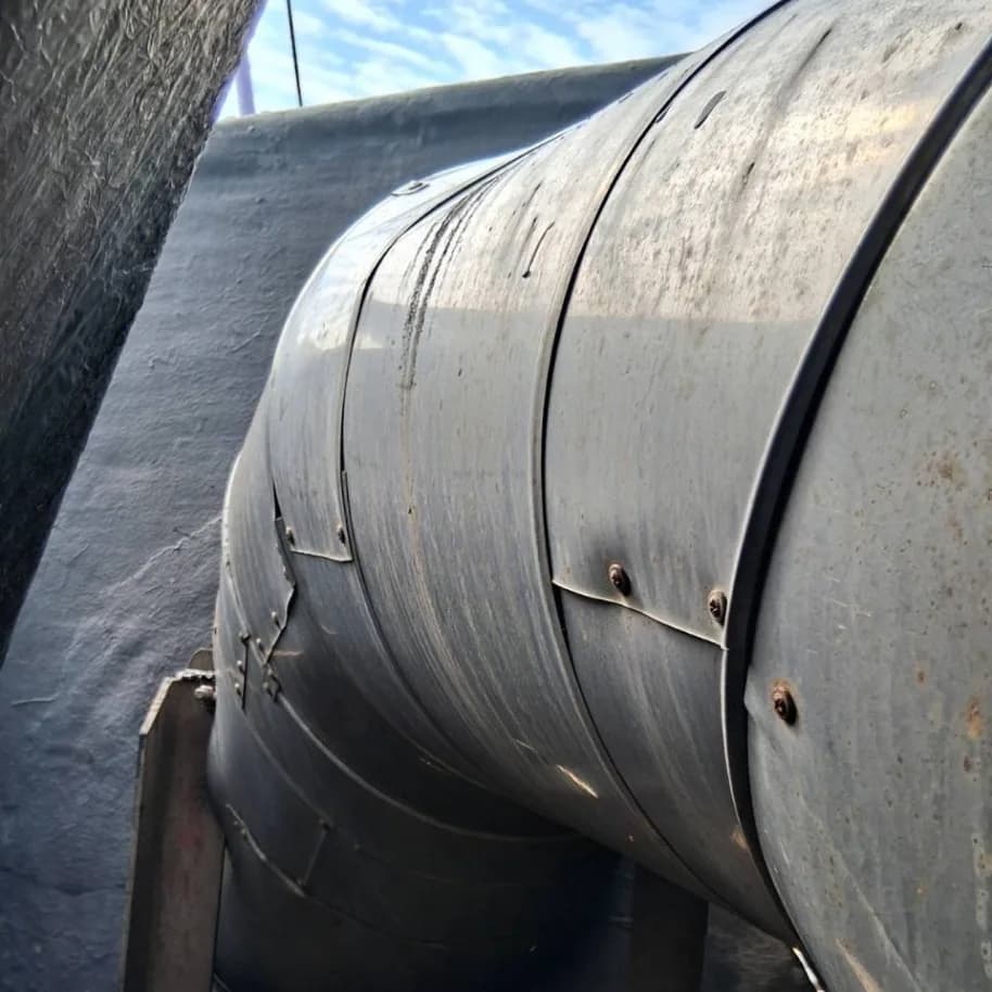 A finished section: insulation under metal cladding, the circumferential joints screwed down and closed off.