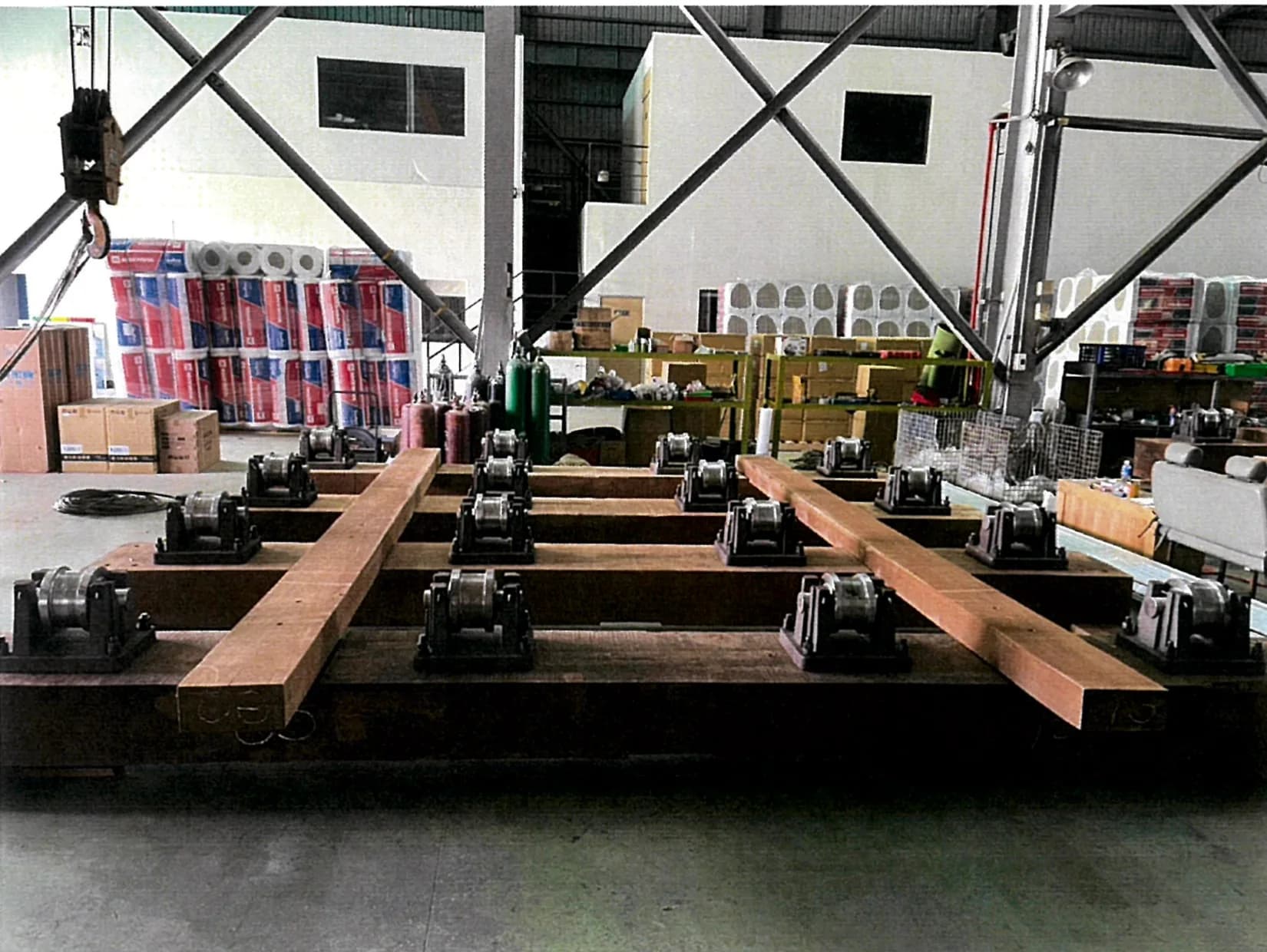 The cradle assembled in the shop — hardwood baulks laid over the steel underframe, with the rows of roller mounts each set and fixed in place.