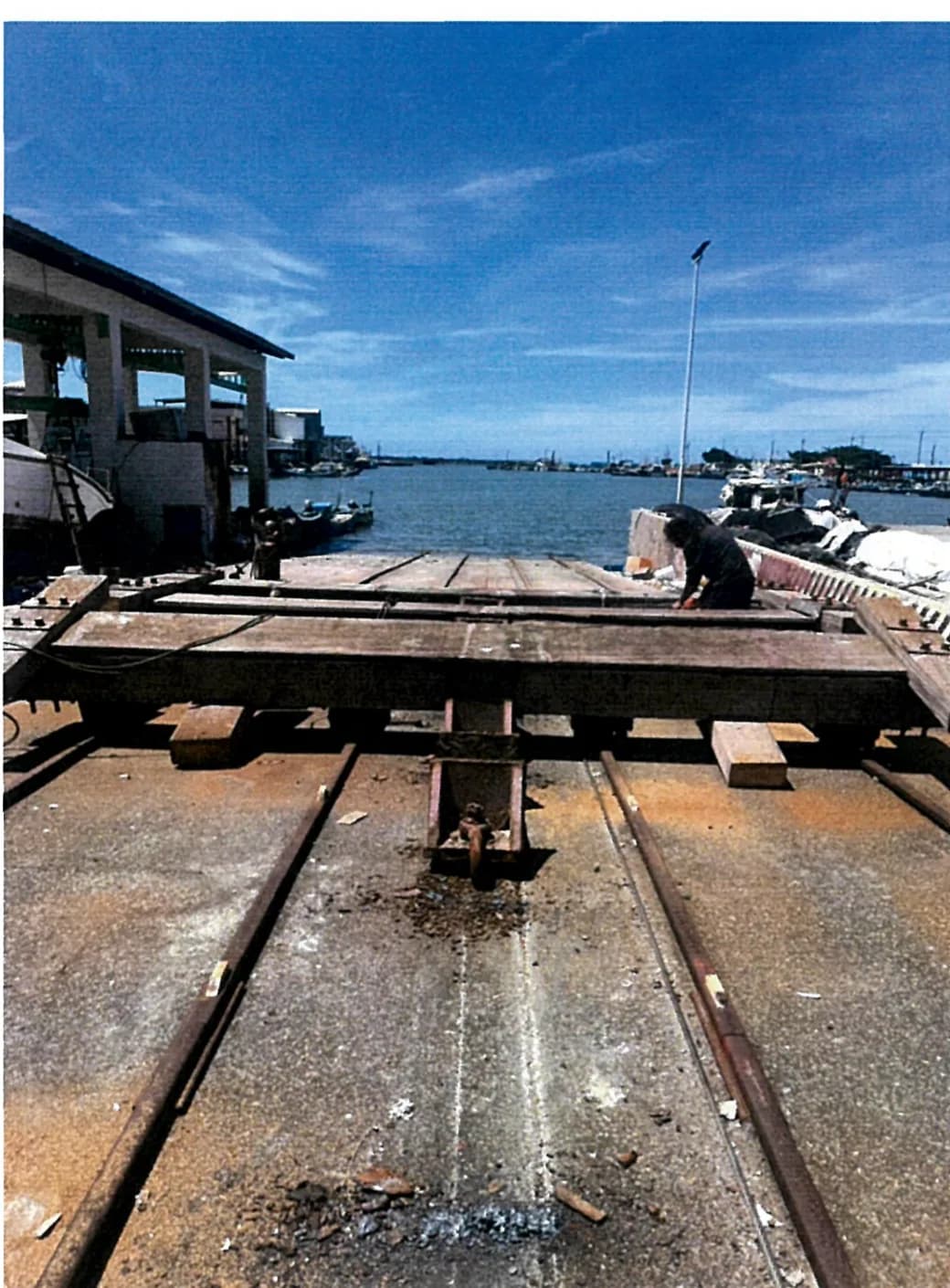 The old cradle being taken apart on arrival, with the rails and slope left as they were.